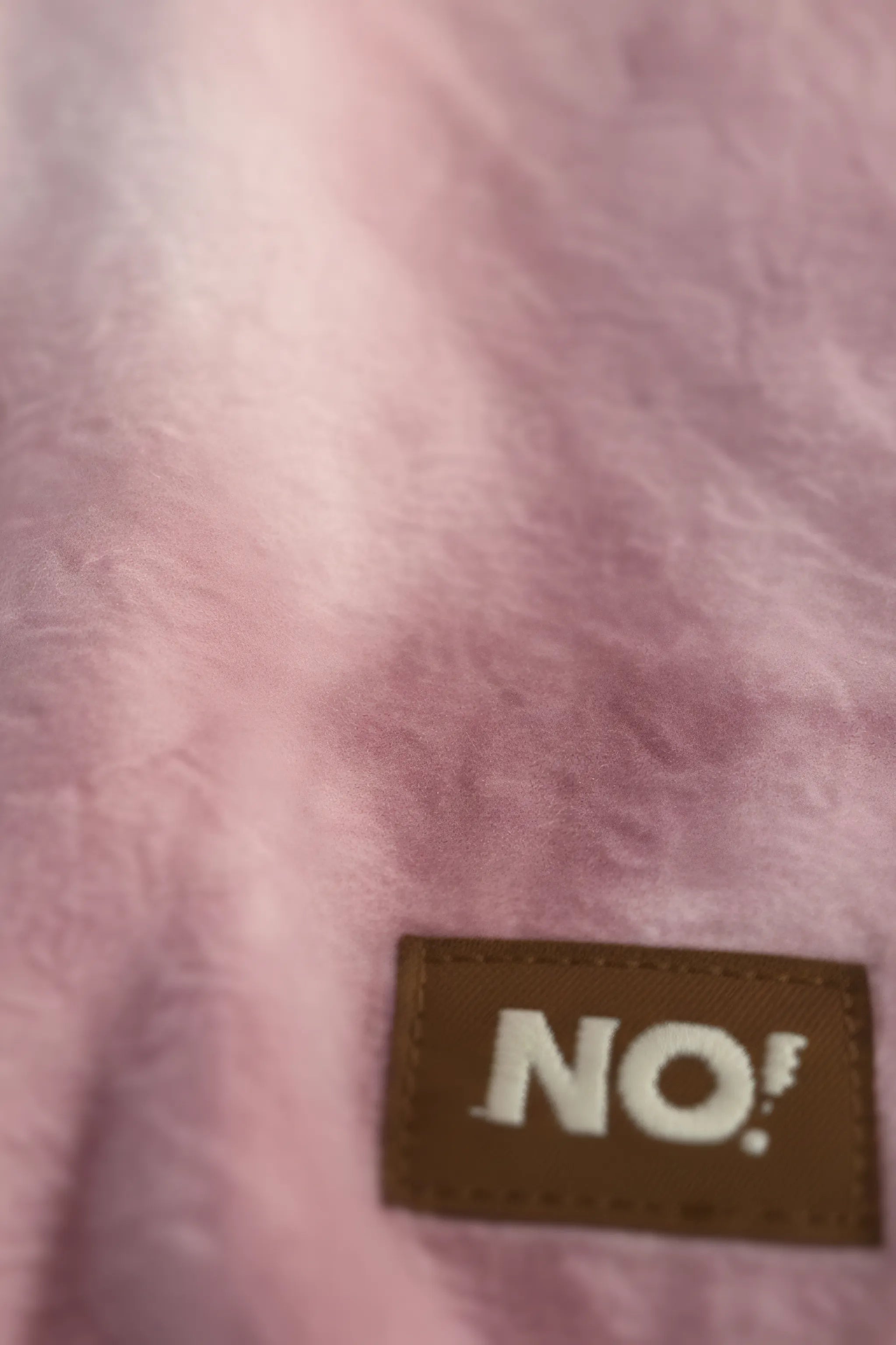 Close-up of a pink Bubba's and Mama's fabric with a brown label displaying the word 'NO!'