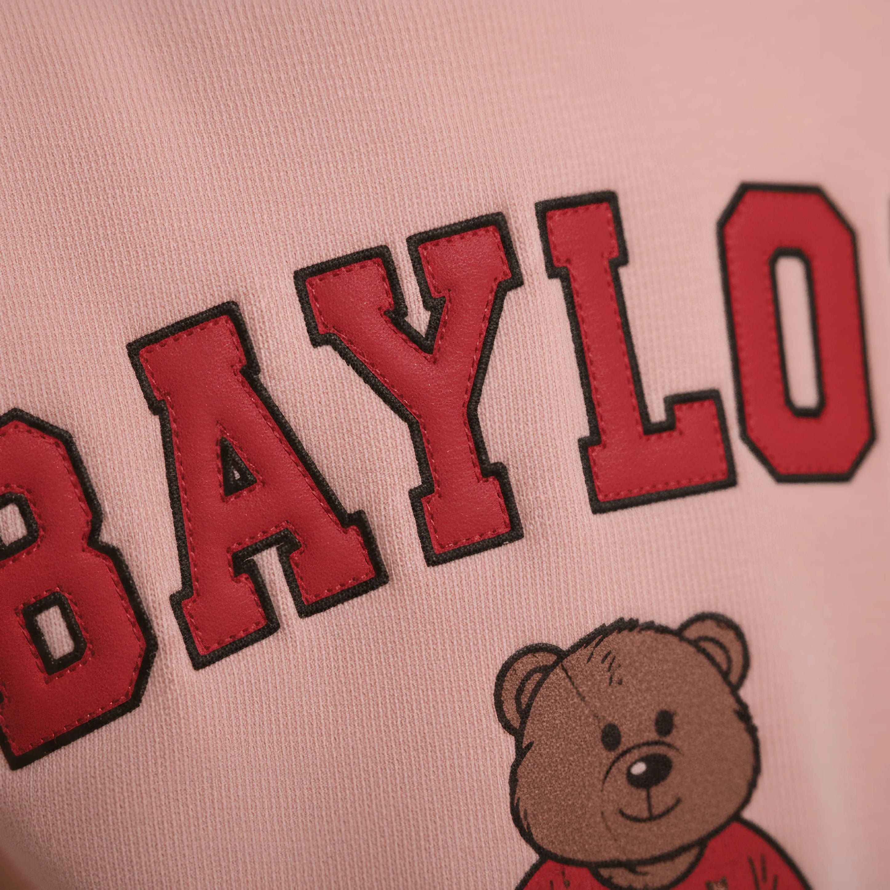 Pink Bubba's and Mama's sweatshirt with red 'BAYLO' text and a bear illustration on a pink background