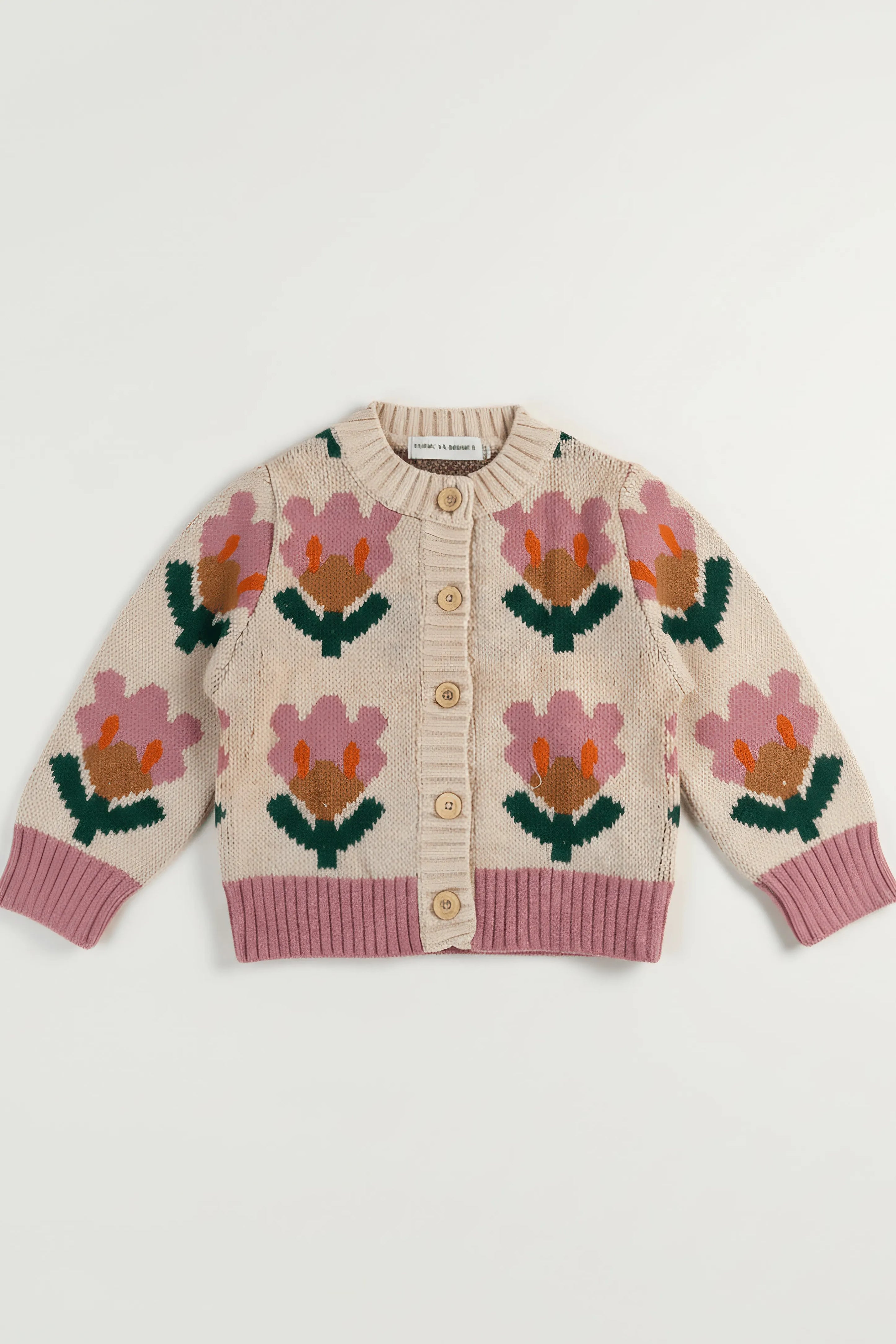 Knitted Bubba's and Mama's cardigan with floral patterns on a white background