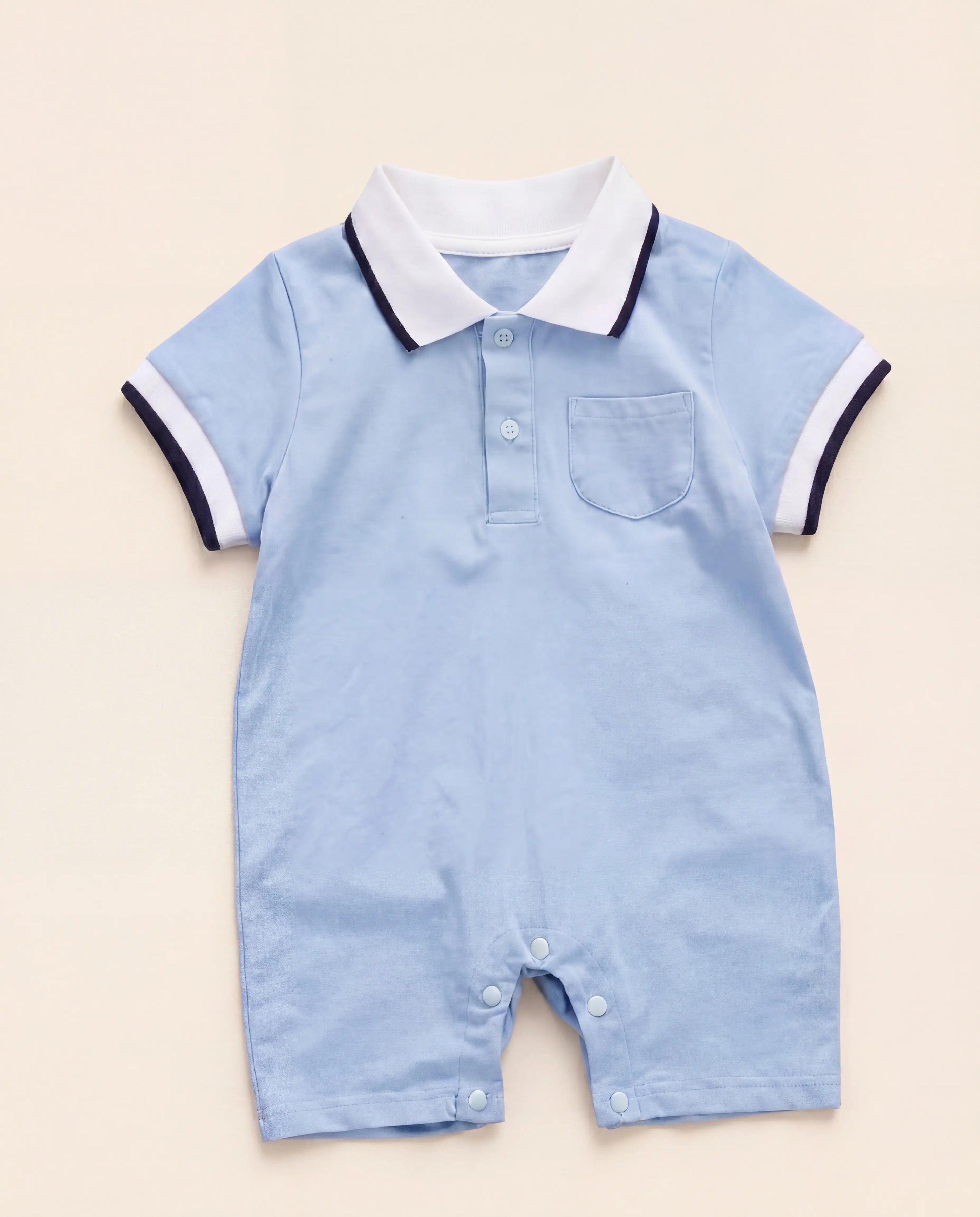 Blue polo baby romper with white collar and short sleeves front view