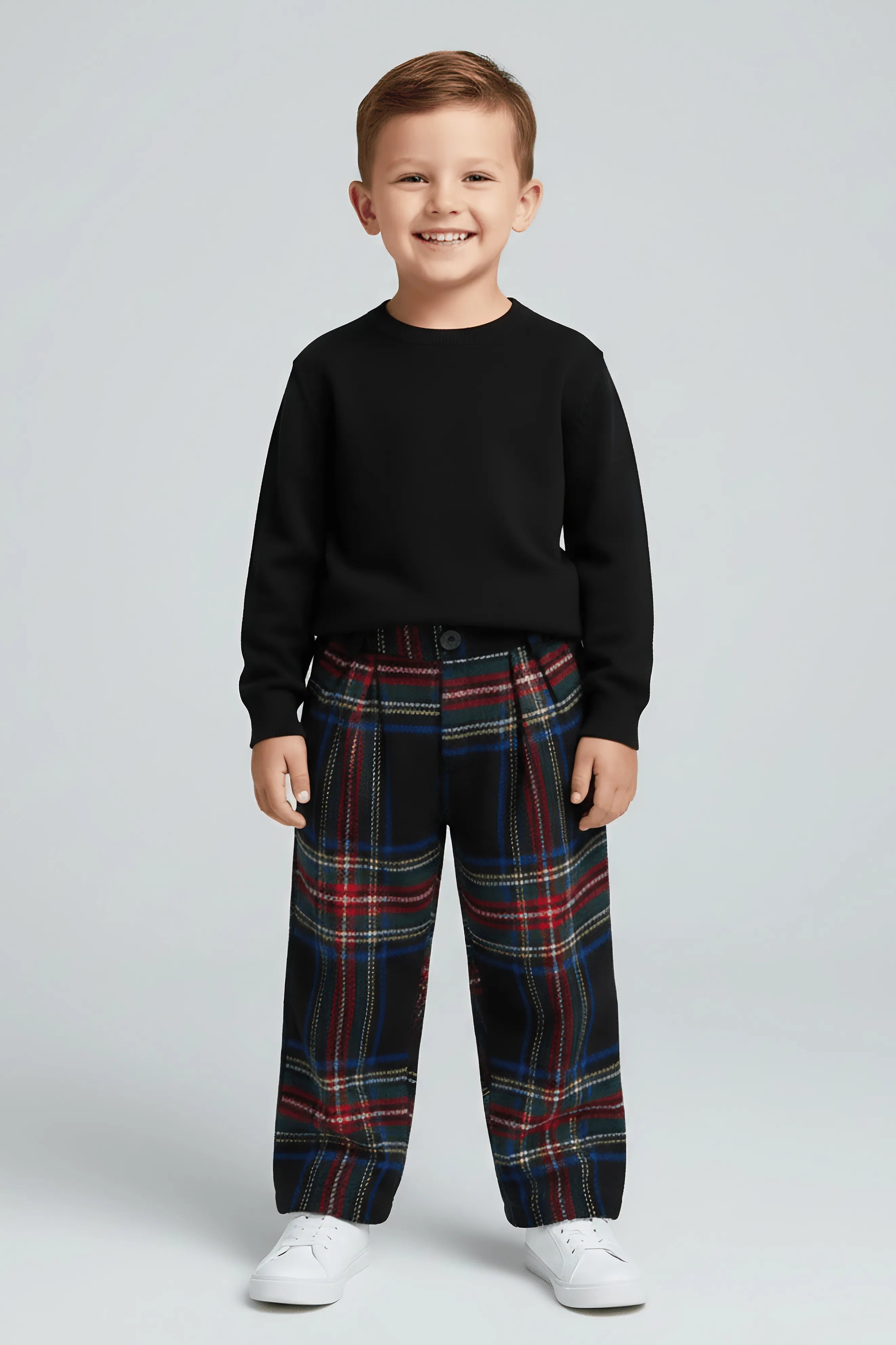 Child wearing a black sweater and plaid Bubba's and Mama's pants on a light gray background