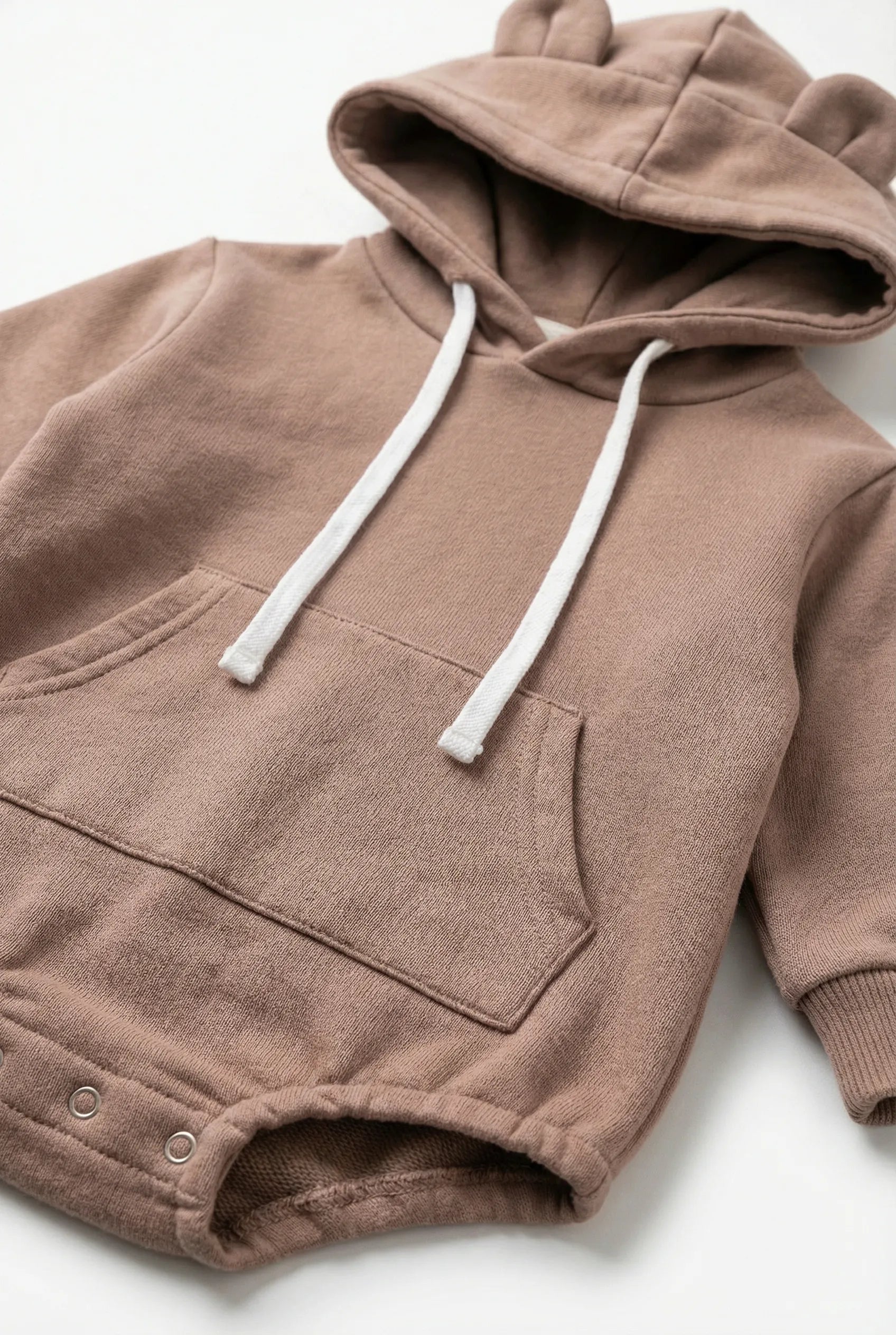 Brown hoodie with white drawstrings on a light gray background