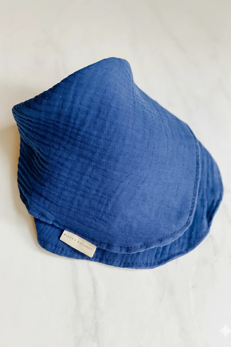 Blue Bubba's and Mama's Lux Muslin Baby Bib with a brand label on a white background