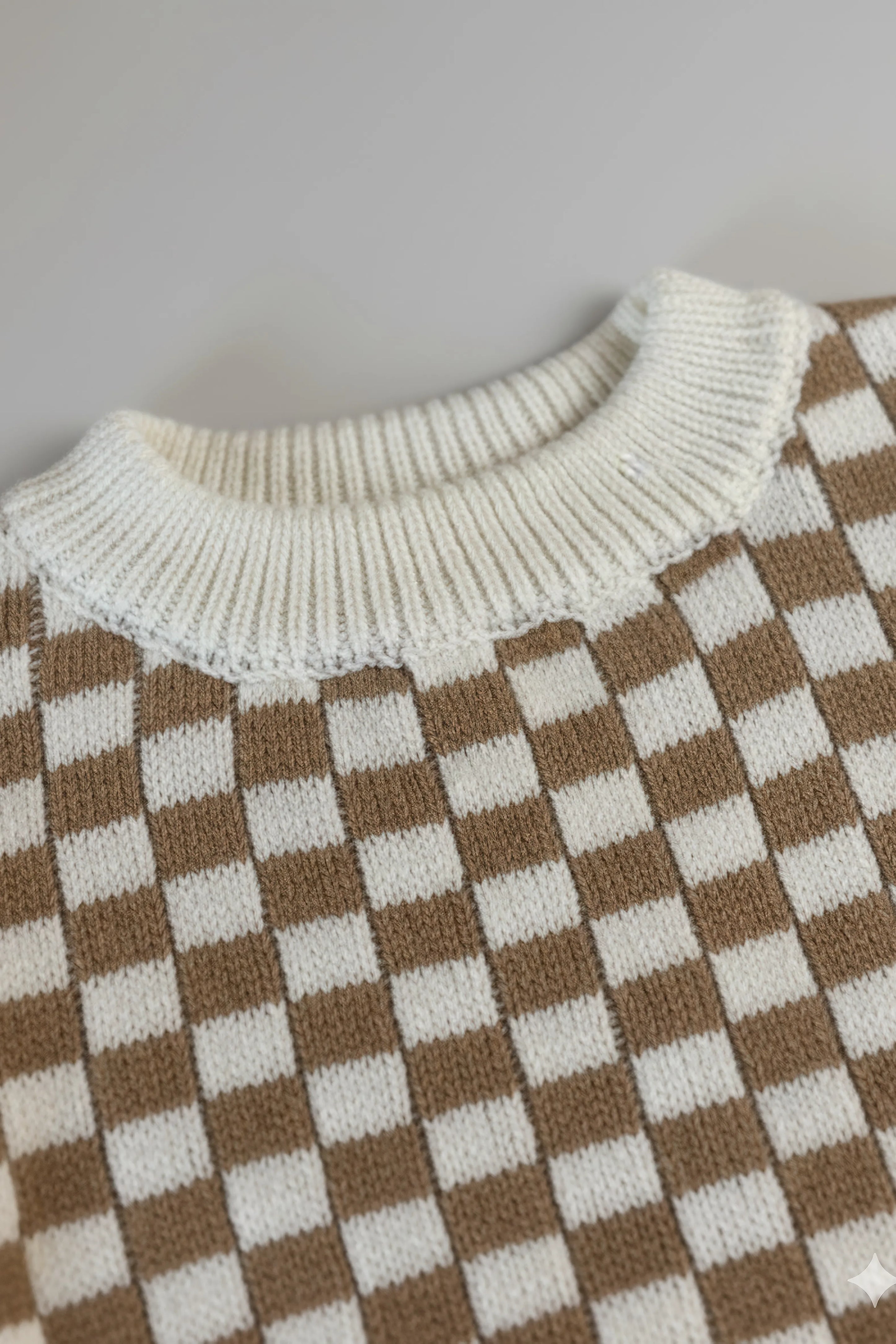 Checkered pattern with white collar on a light gray background