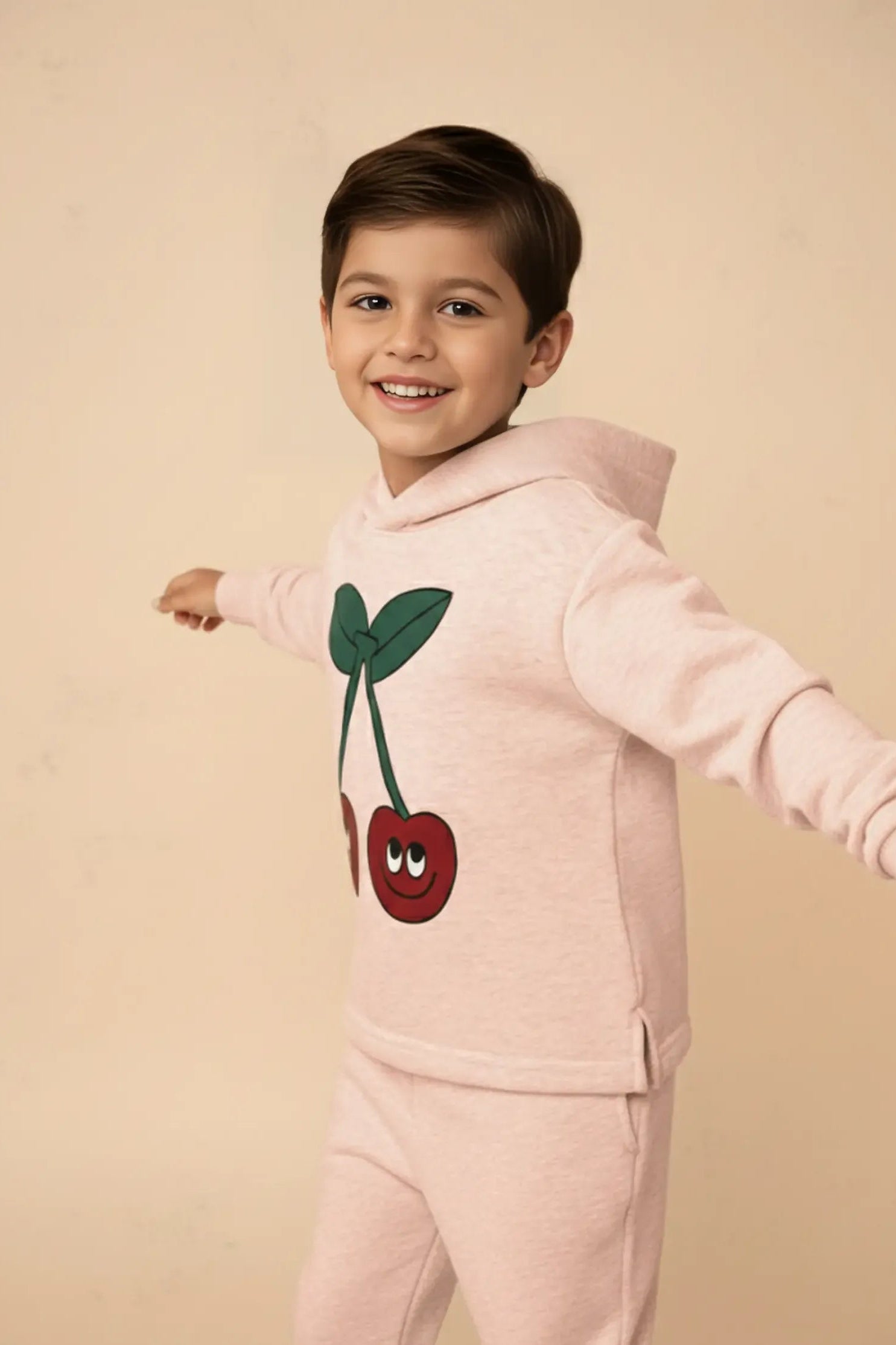 Child wearing a pink Bubba's and Mama's hoodie with cherry design on a beige background