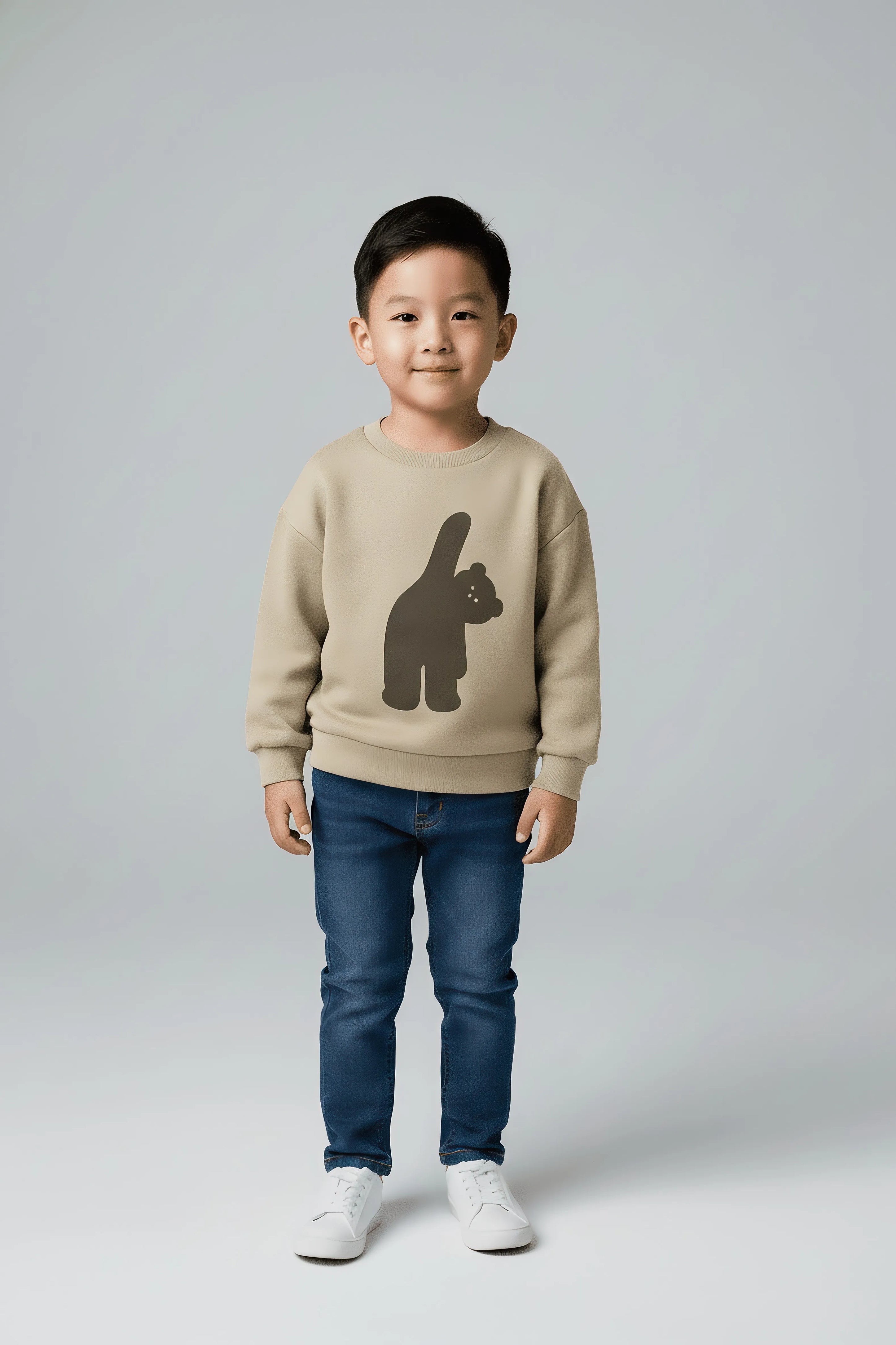 Child wearing a beige Bubba's and Mama's sweater with a bear graphic and blue jeans on a light gray background