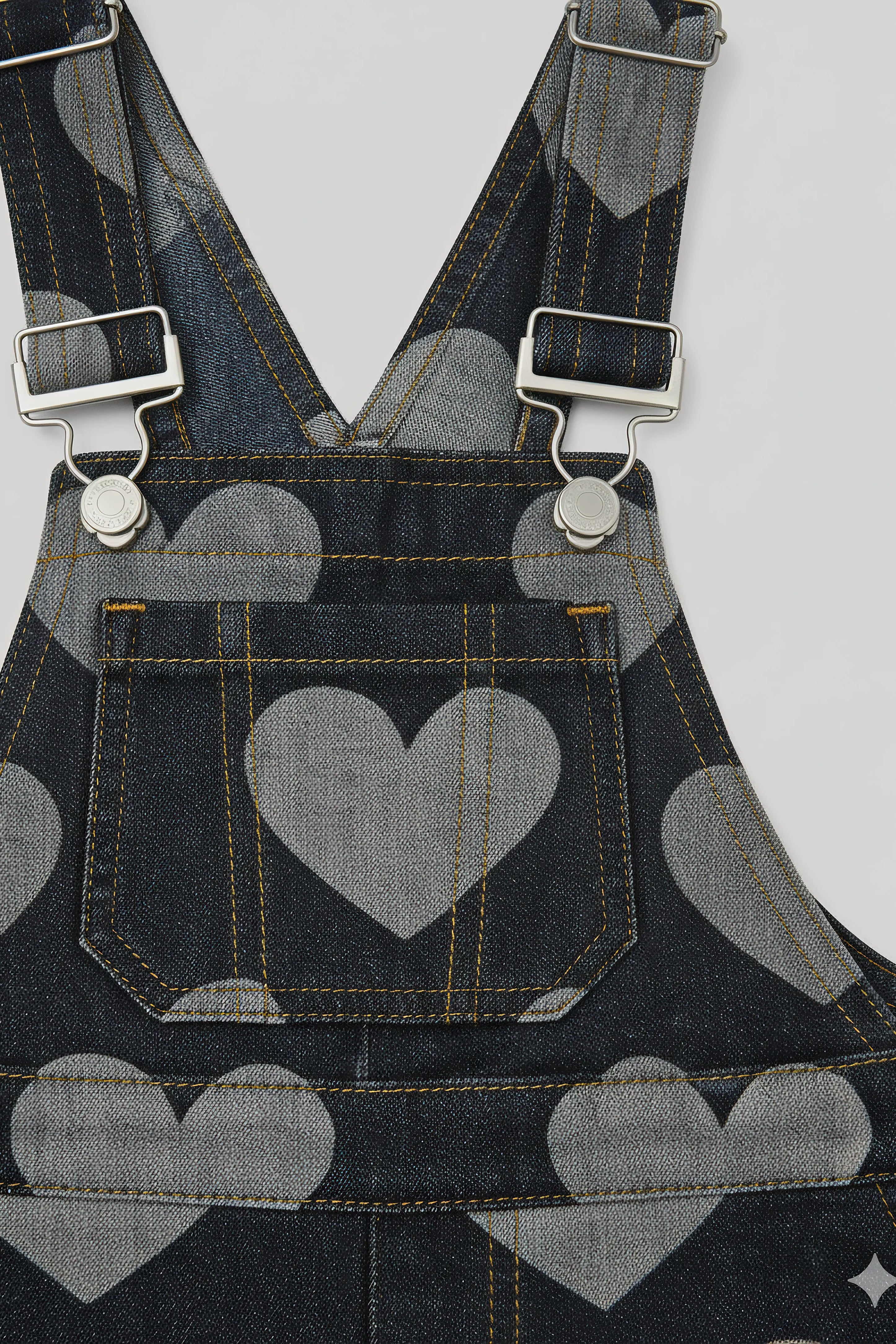 Denim overalls with heart Bubba's and Mama's pattern and plaid straps on a white background