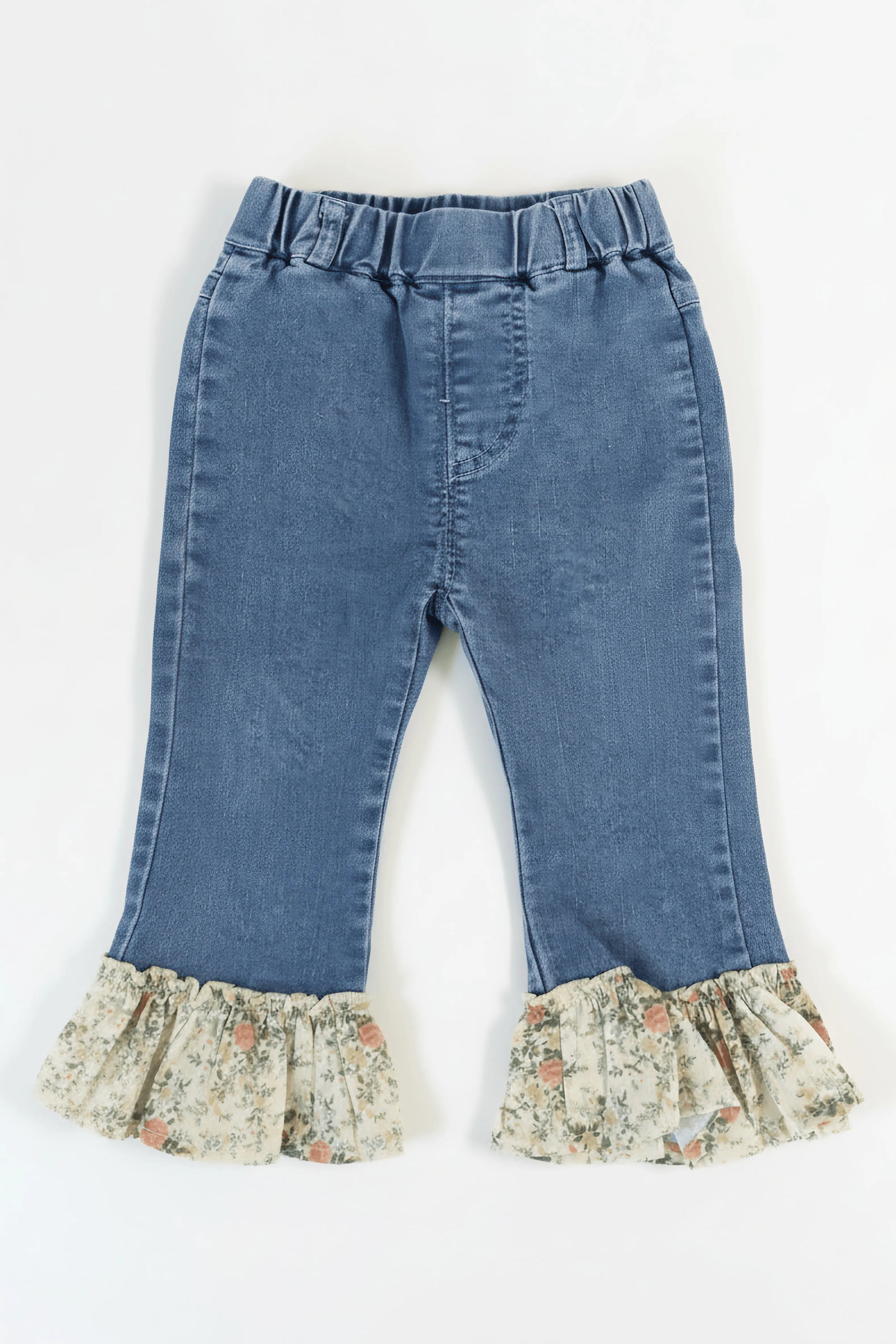 Blue jeans with floral ruffles on a white background