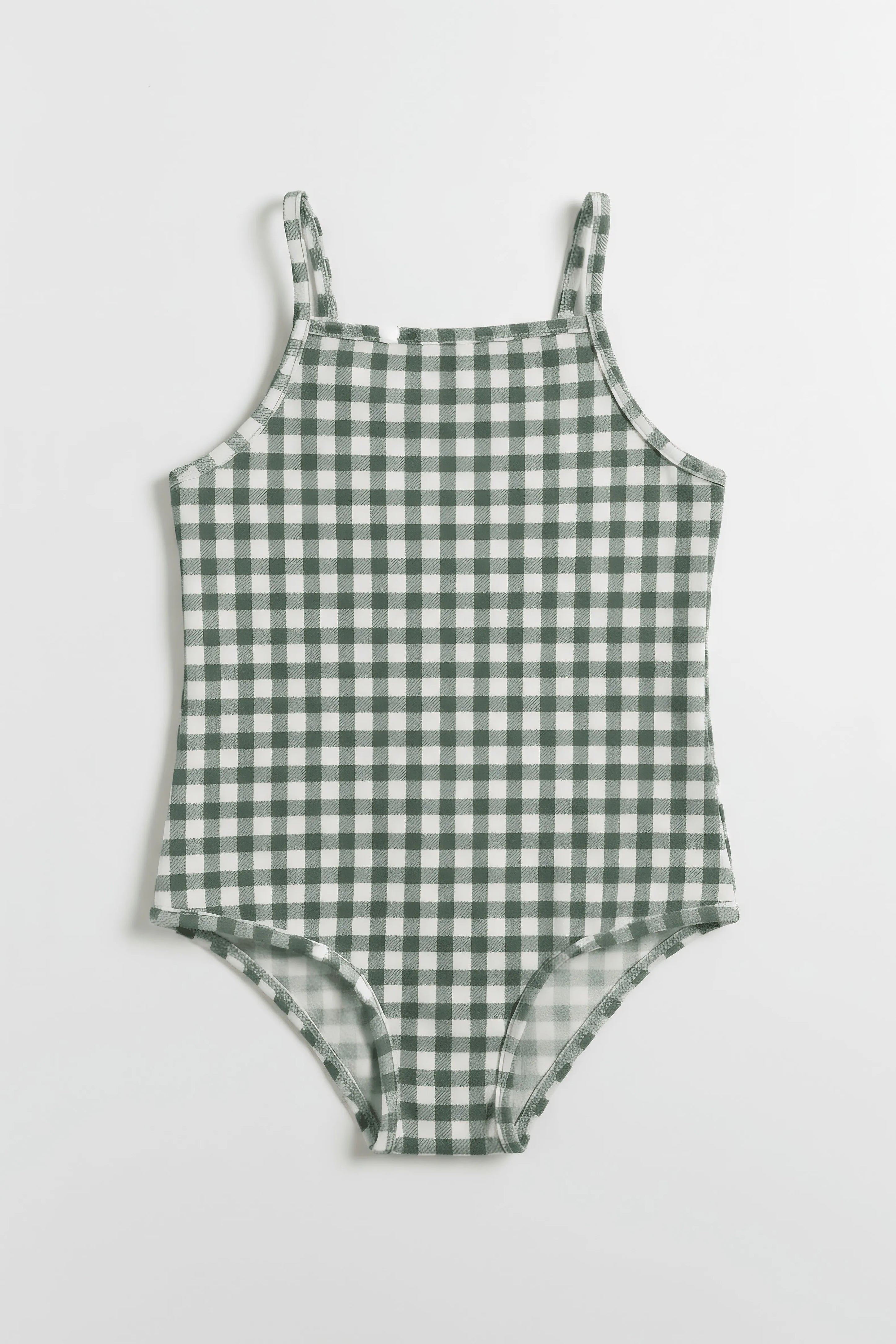 Green and white checkered romper on a light gray background