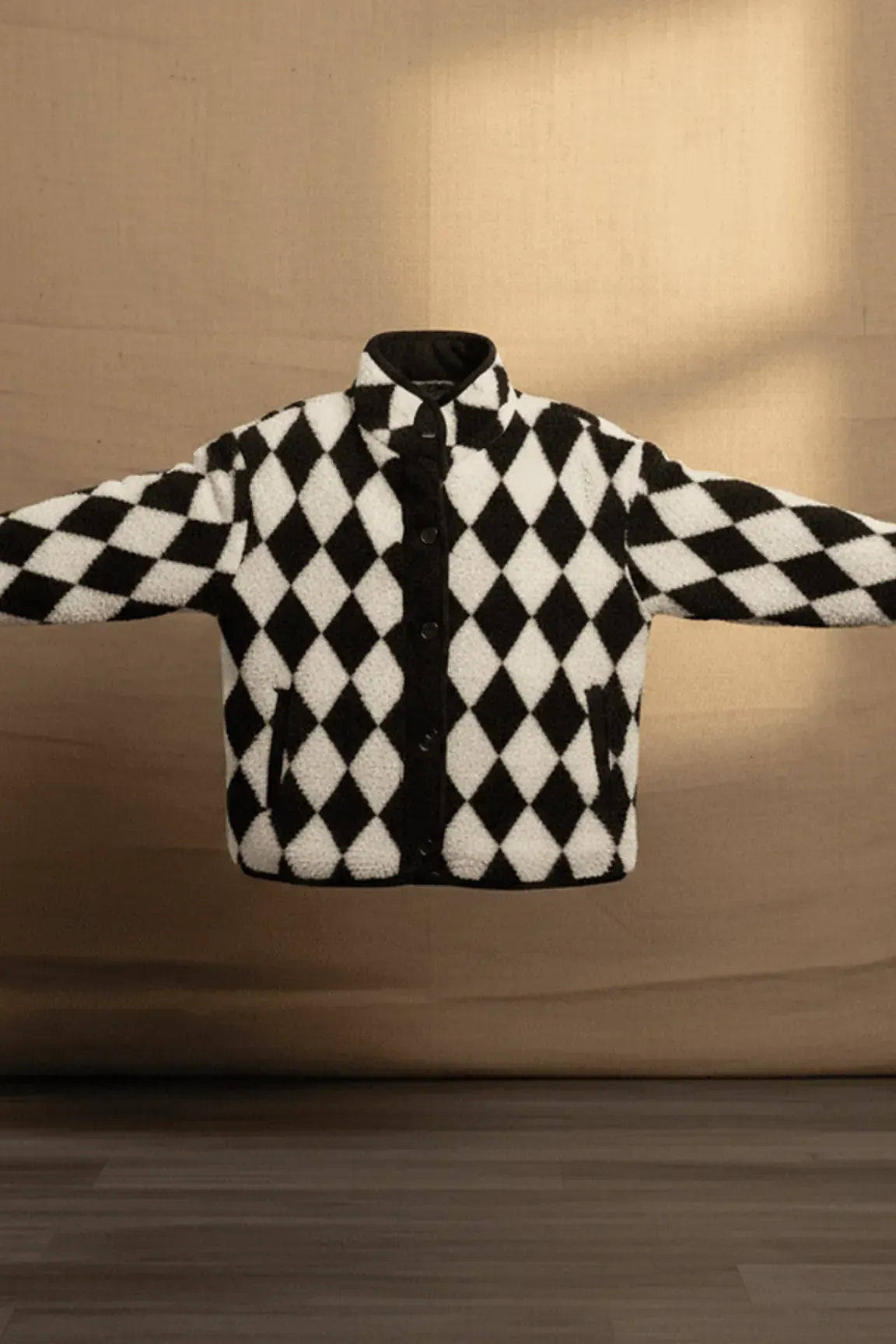 Black and white checkered jacket on a beige background