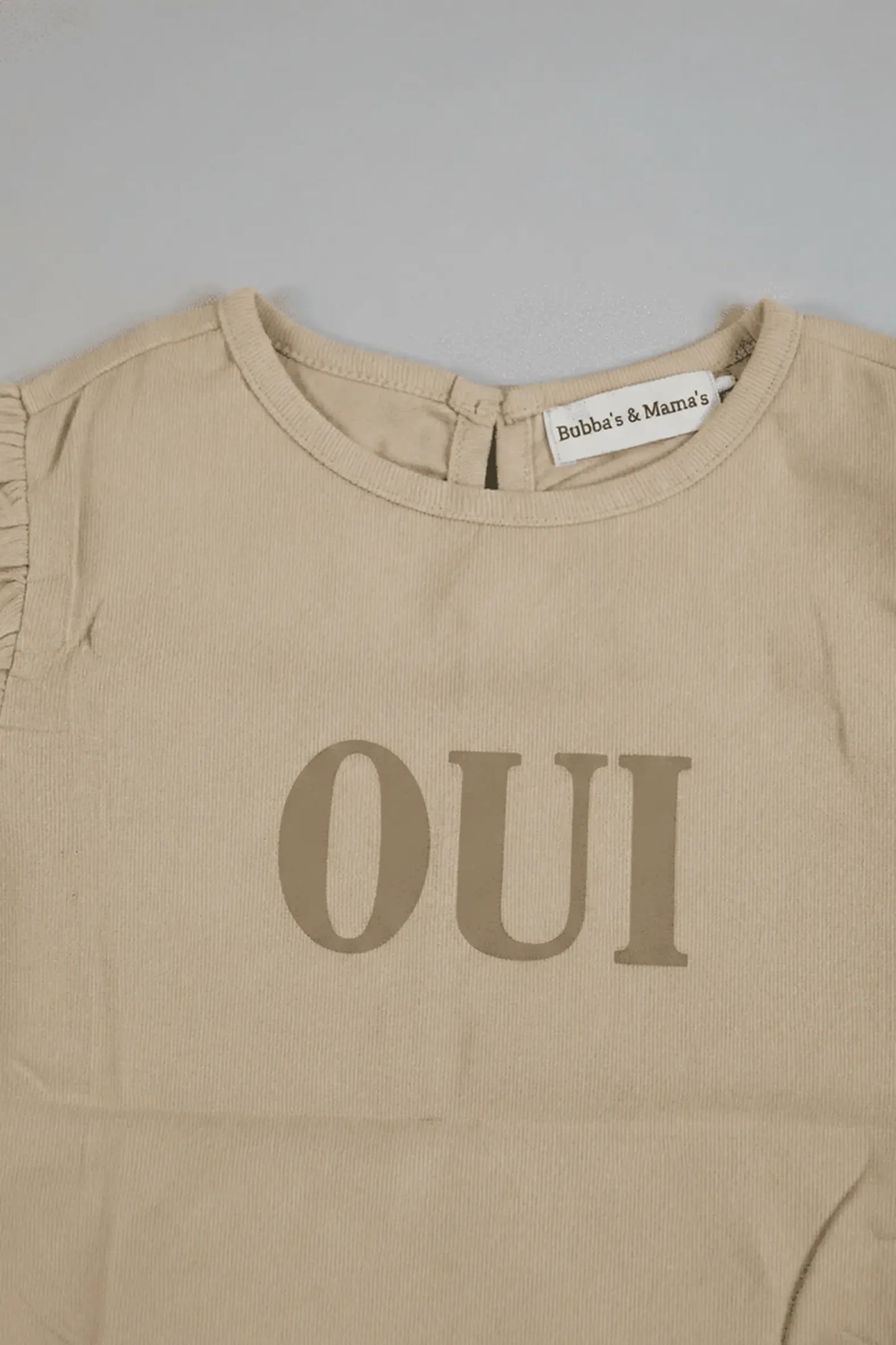 Beige Bubba's and Mama's shirt with 'OUI' text on a gray background
