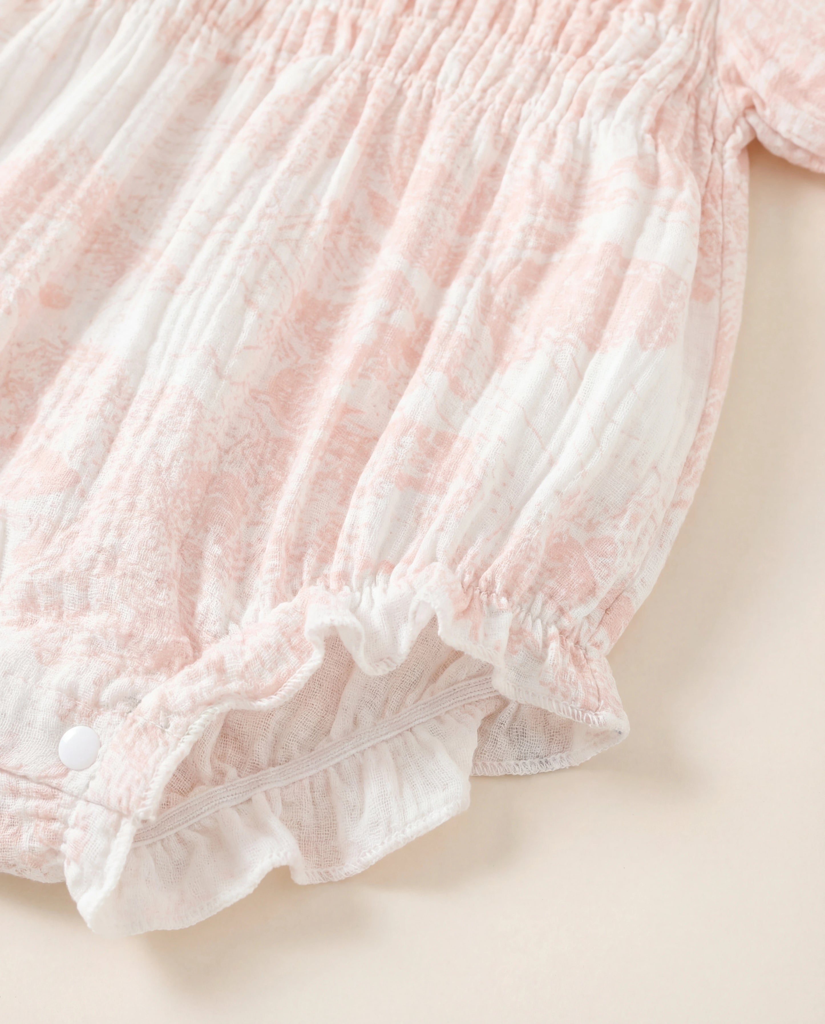 Close-up of a pink textured fabric garment on a light background