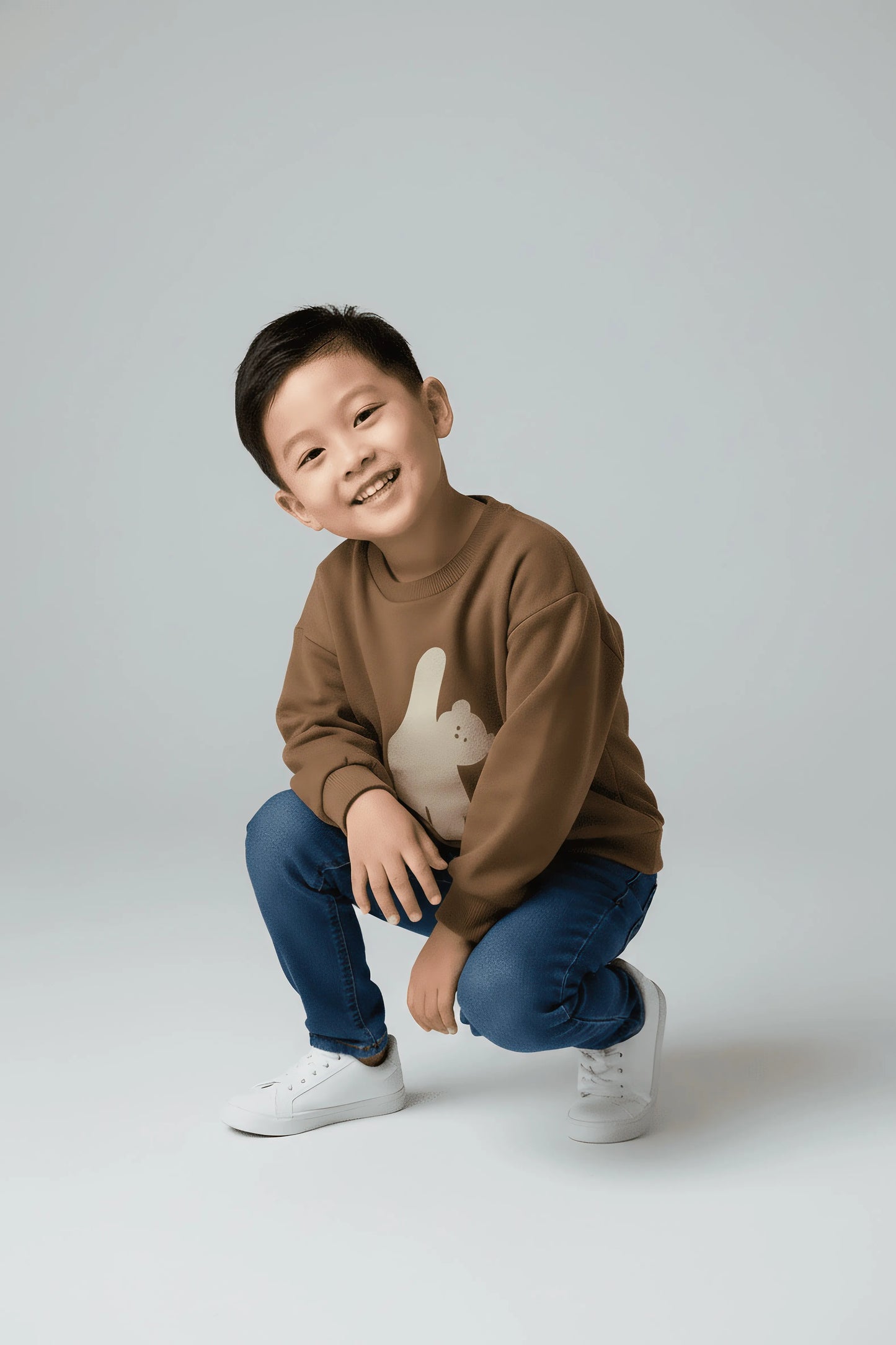 Child wearing a brown Bubba's and Mama's sweater with a graphic design on a plain background