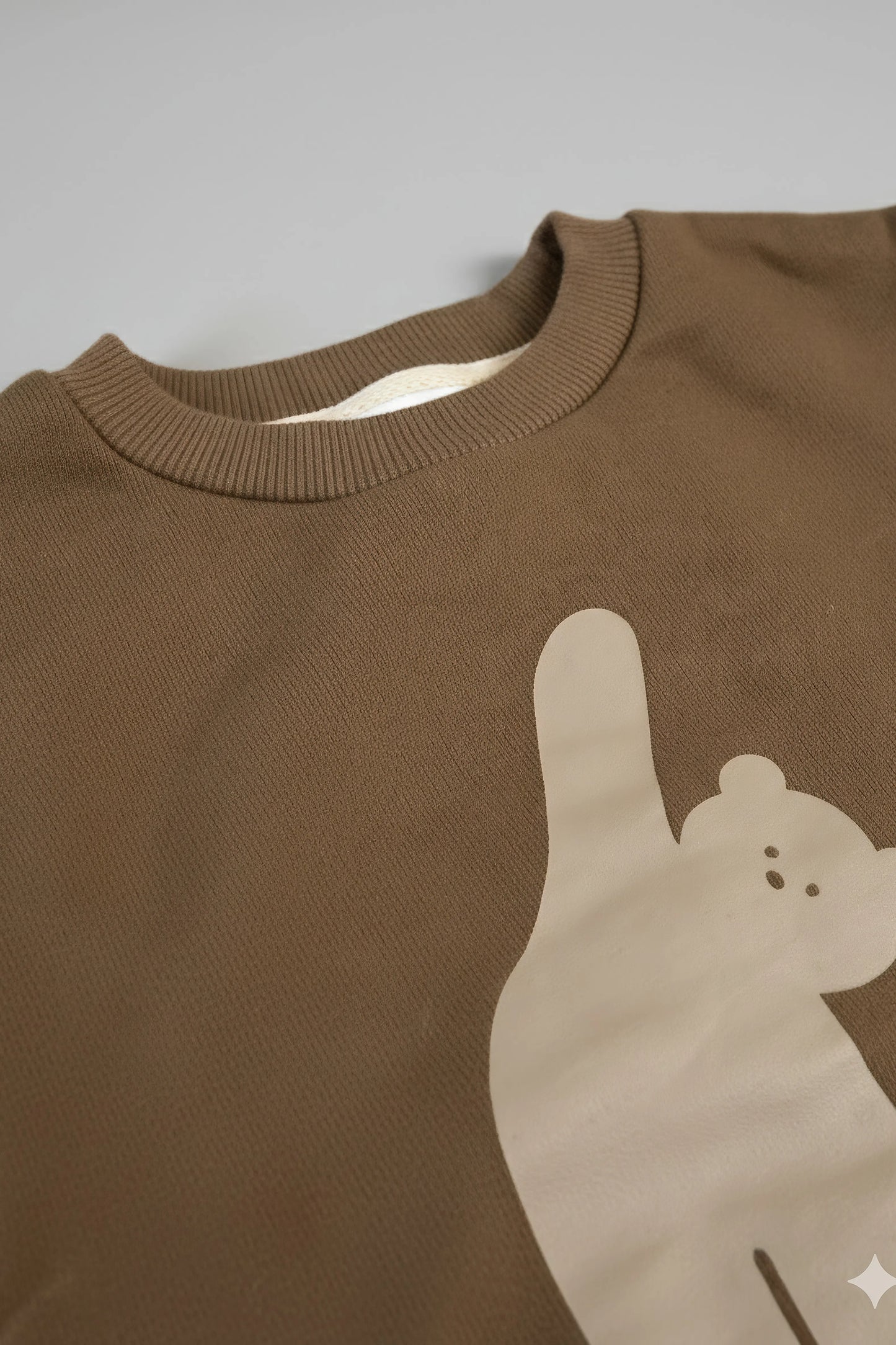 Brown Bubba's and Mama's sweater with a bear design on a gray background