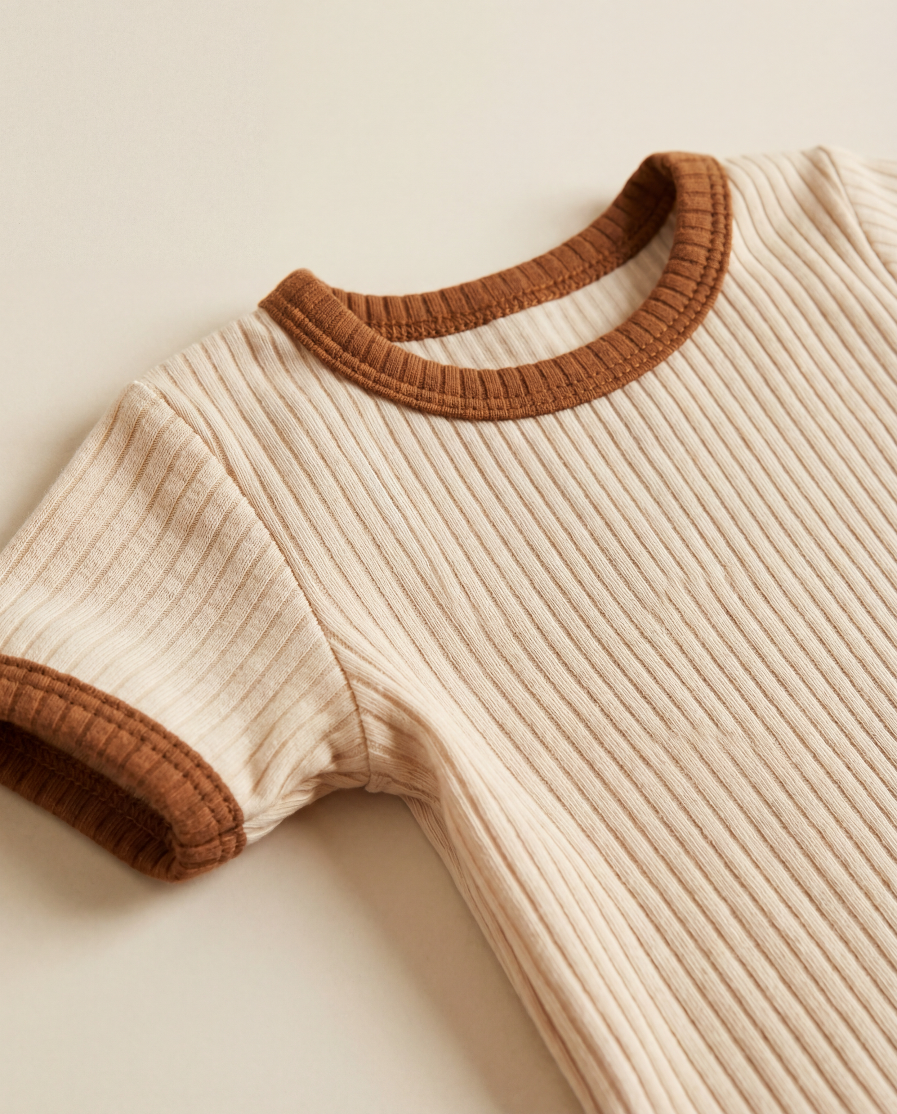 ribbed cotton baby romper fabric close up soft sand color stretch knit texture